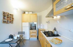 a kitchen with a stove and a table in it at Cozy Home In Chiavari in Chiavari