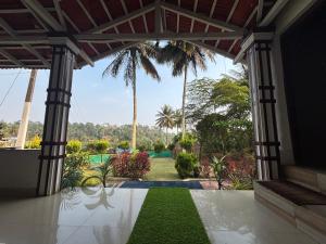 a view of a garden from the inside of a house at Kings Villa Homestay Coorg in Madikeri