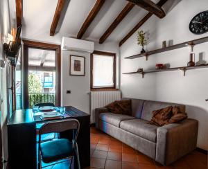 a living room with a couch and a table at Oasi Piacentina in Piacenza