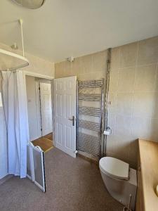 a bathroom with a tub and a toilet and a sink at Greenways at Coed Cae Farm in Pontnewydd +75 photos