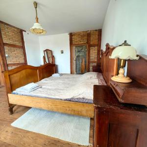 a bedroom with a bed and a lamp on a table at Pensjonat Stara Szkoła in Piaseczno