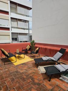 a group of chairs and tables on a patio at City Center Terrace in Faro