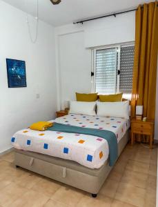 a bedroom with a large bed in a room at Casa Jana in Los Alcázares