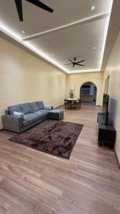 a living room with a couch and a table at Cosy Nest Homestay with 60 inch 4K android TV in Muar +10 photos