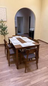 a wooden table with chairs in a room at Cosy Nest Homestay with 60 inch 4K android TV in Muar