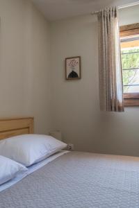 Postel nebo postele na pokoji v ubytování Limeri Apartments