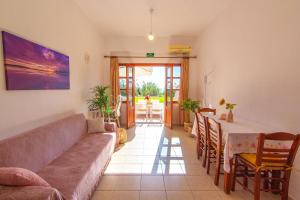 a living room with a couch and a table at Liviko Beach Apartments - only adults in Frangokastello
