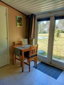 a room with a wooden table with chairs and a window at Printemps Quatre Saisons in Bergerac +23 photos