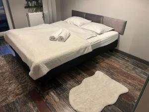 a bedroom with a bed with two towels on it at Apartament z dwoma sypialniami i tarasem in Płock