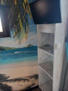 a wall with a painting of the beach at Roulotte de Camille, avec bain à remous in Winnezeele