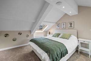 a bedroom with a large white bed and a window at Stylish 7 Bedroom House in Plymouth