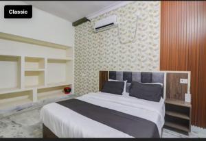 a bedroom with a large bed in a room at Bhoomi Palace Hotel in Gorakhpur