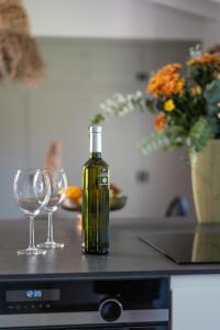 a bottle of wine and two wine glasses on a counter at Casa Dona in Denia