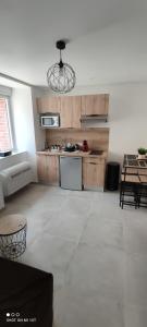 a living room with a kitchen and a table at Les Suites du Relais in Saint-Martin-dʼAblois +28 photos