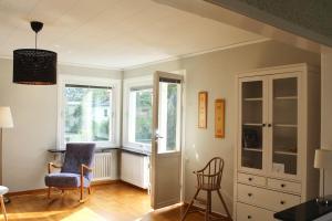 a living room with a chair and two windows at Villa Blueberry in Överum