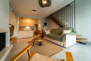 a living room with a couch and a table at Aegean Twin Houses in Iraklitsa