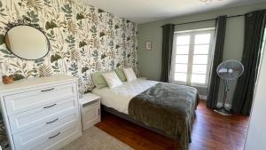 a bedroom with a bed and a mirror and a window at Maison Rose in Dognen