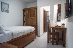 a bedroom with a bed and a table and a chair at At home Douala Cameroun in Douala