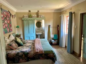a bedroom with a bed with a blue door at Villa Afriq in Lydenburg +44 photos