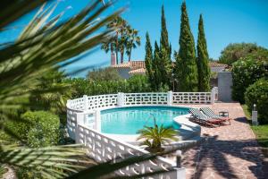 a swimming pool with a white fence around it at Casa Dona in Denia +28 photos