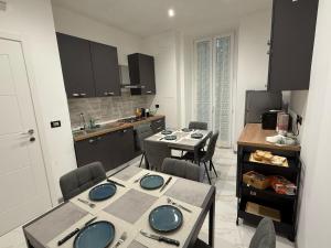 a kitchen with a table and chairs in a room at Casa B&B Paganini -If you book 2 rooms you have the whole house to yourself in Savona