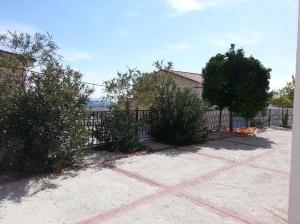 a house with bushes in front of a fence at La Casita de Ventorros in Loja
