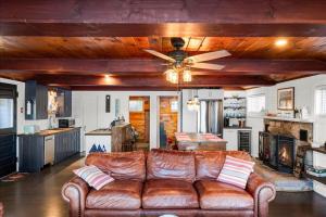 a living room with a couch and a ceiling fan at Waterfront w/ Prvt Dock & Firepit | Sleeps 8 in Acton
