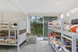 a bedroom with two bunk beds and a window at Miranda Oasis in Torquay +14 photos