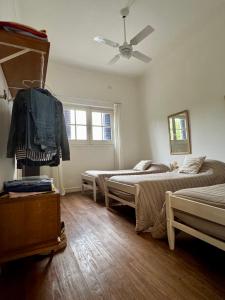a bedroom with two beds and a ceiling fan at Lo de Nina in Azul