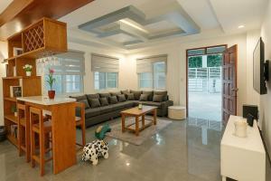 a living room with a couch and a table at Jachim and Boaz FarmVille Staycation in Tagaytay