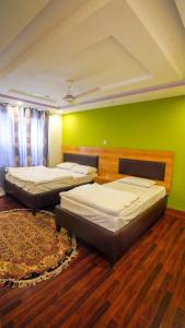 Ένα ή περισσότερα κρεβάτια σε δωμάτιο στο Hargisa In Hotel Skardu