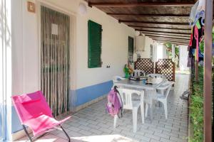a patio with a table and chairs on a house at Camping Villaggio Il Frutteto in Cupra Marittima