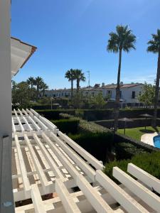 a row of white benches sitting on the side of a building at El Rompido in El Rompido
