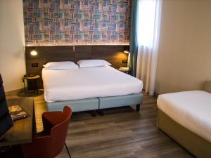 Ένα ή περισσότερα κρεβάτια σε δωμάτιο στο Hotel Ambra