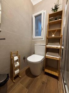 a small bathroom with a toilet and a window at Apartamento Laredo con Terraza in Laredo +20 photos