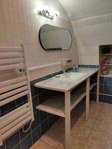 a bathroom with a sink and a mirror at Au coeur de la vieille ville, Chambre privée indépendante in Sommières