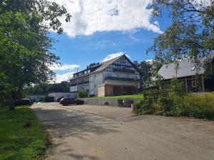 a large building with a car parked in front of it at Great apartment Winterberg WOODS in Medebach