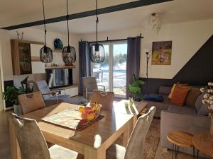 a living room with a table and a couch at Great apartment Winterberg WOODS in Medebach