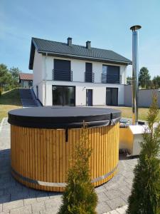 a house with a large barrel in front of it at GaLu- Trelkowko 1 in Kobyłocha +6 photos