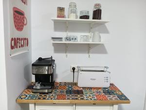 a coffee maker on a counter in a kitchen at Trafalgar Royal in Adra +10 photos