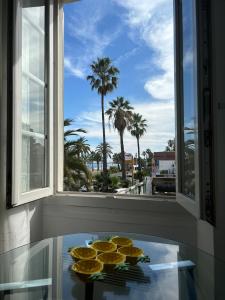 a window with a table with cookies on top of it at Cozy studio sur la promenade in Nice +10 photos