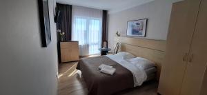 a bedroom with a bed and a window at Koral in Władysławowo