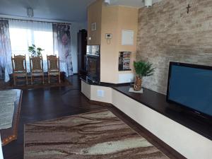 a living room with a large flat screen tv at Kamienny Gościniec in Kopanica