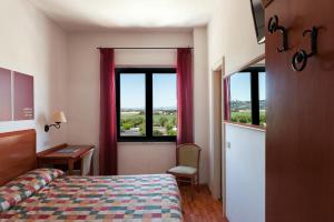 Postel nebo postele na pokoji v ubytování Hotel Brigantino Non Dista