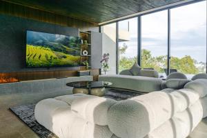 a living room with a couch and a table at Amulya Luxury Villa, Dago - 4BR Heated Infinity Pool in Bandung