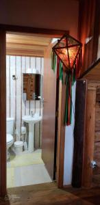 a bathroom with a toilet and a sink at Pousada Recanto da Pantera in Cunha +86 photos