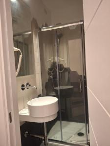 a bathroom with a sink and a glass shower at Hotel Viennese in Rome +11 photos