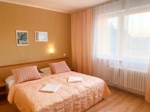 a bedroom with a bed with two towels on it at Penzión na Sihoti in Trenčín