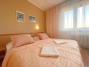 a bedroom with a bed with two towels on it at Penzión na Sihoti in Trenčín