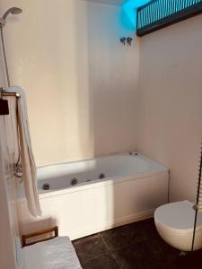 a white bath tub in a bathroom with a toilet at Casa Amici - Luxe in Cadaqués in Cadaqués +33 photos